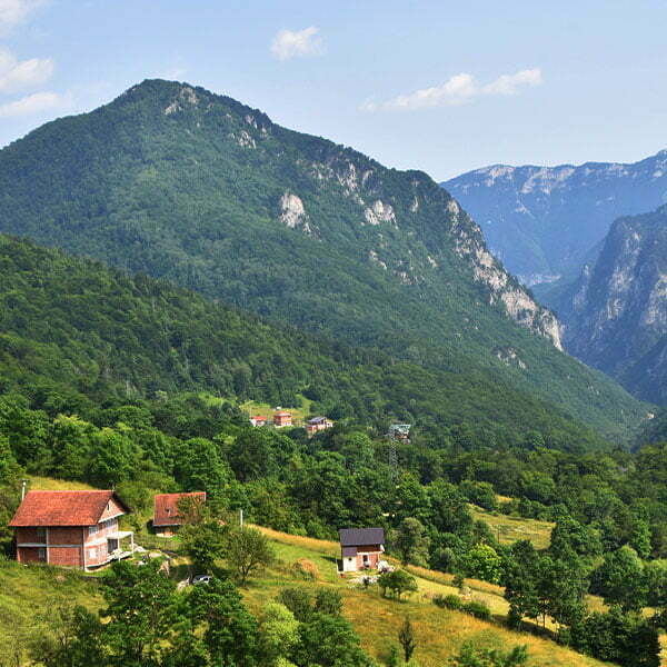 A photo of a valley with houses in the Boge Mountains of Kosovo.