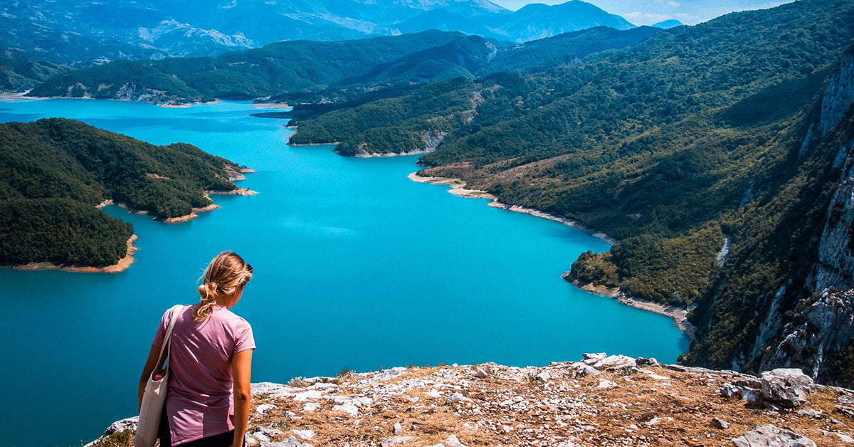 the stunning Bovilla Lake in Albania, with its crystal-clear waters and lush green surroundings.