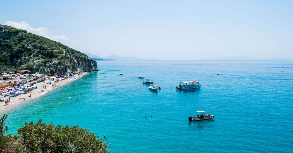 A beach with boats in the Ionian Sea in Albania.