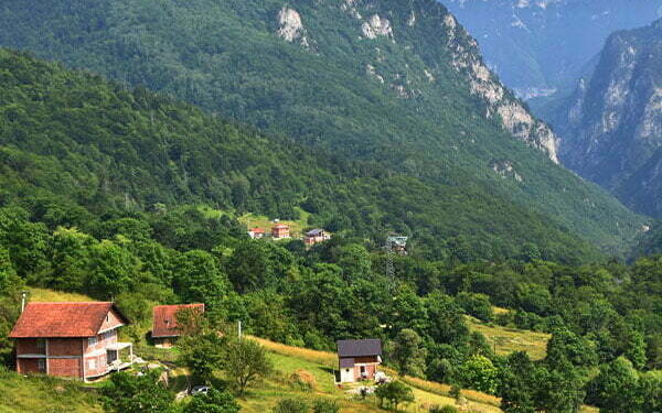 A photo of a valley with houses in the Boge Mountains of Kosovo.