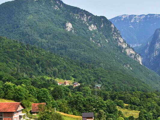 a valley with houses in the Boge Mountains of Kosovo.