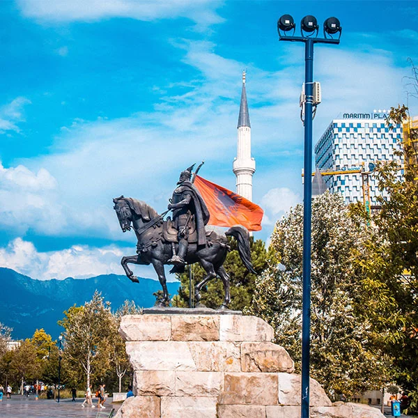 Skanderbeg statue in Skanderbeg Square with Et'hem Bey Mosque in the background in Tirana, Albania.