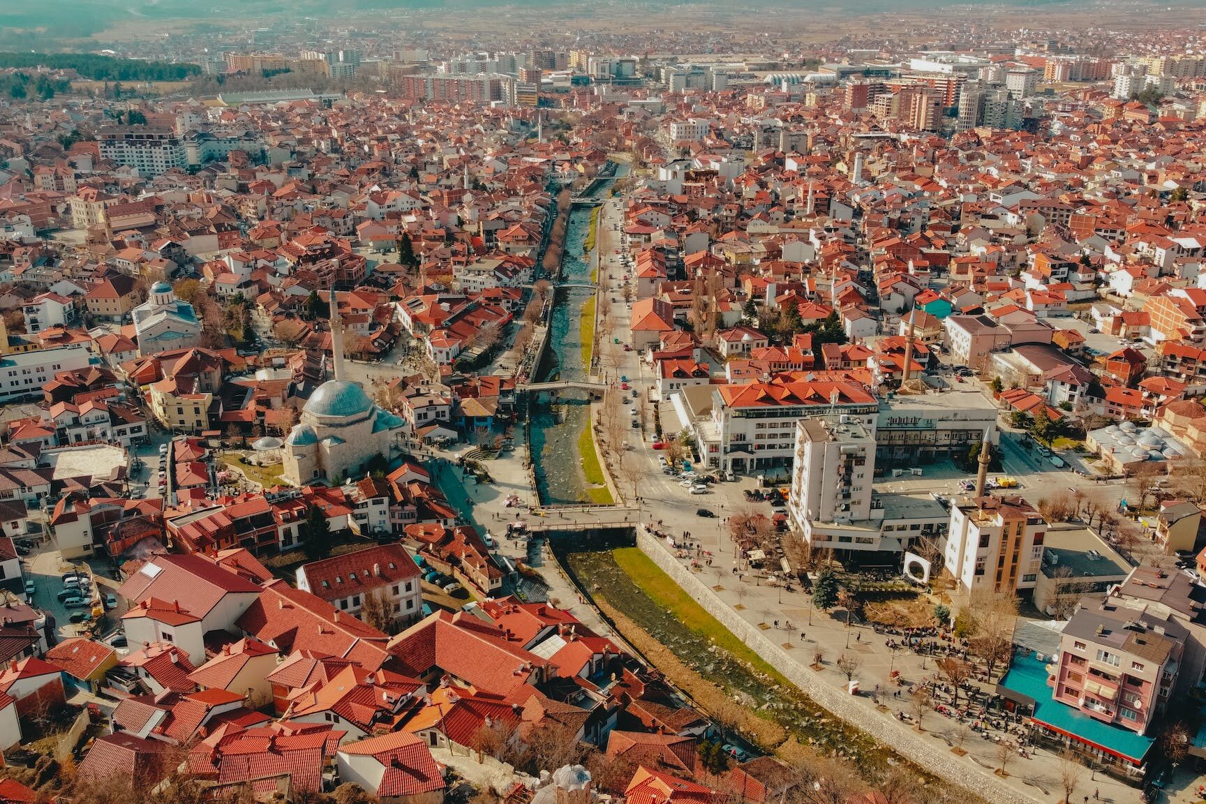 Drone Shot of a River Surrounded by Houses and Buildings in Prizren Kosovo