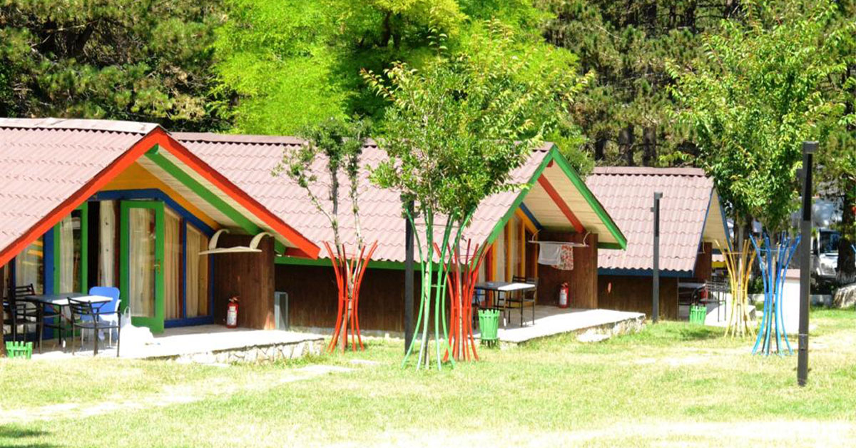 A traditional house, with its white-washed walls, red-tiled roof, and wooden shutters in Llogara National Park Albania