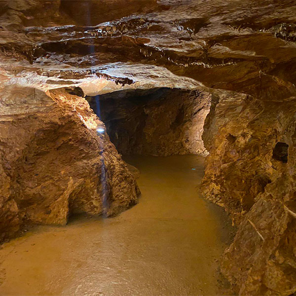 A close-up of Gadime Cave, showing its stalagmites, stalactites, and other cave formations.