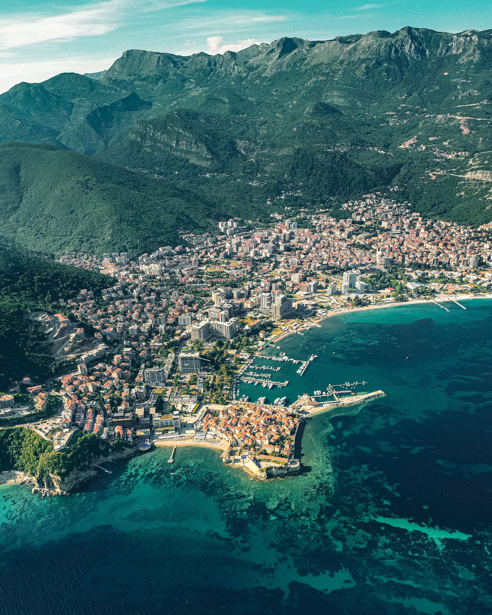 Aerial view of Budva city between green mountains and the Adriatic Sea in Montenegro