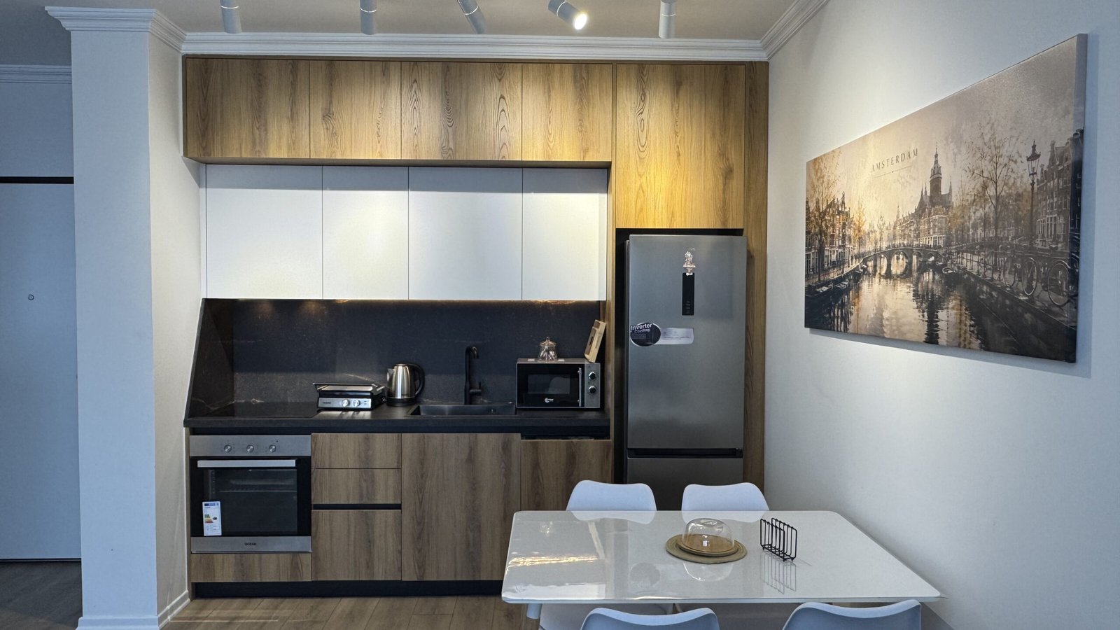 Kitchen with modern appliances at Amsterdam Apartment in Tirana
