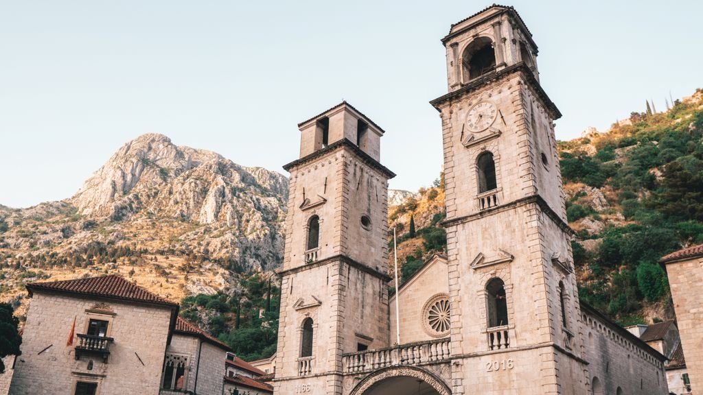 Cathedral of Saint Tryphon in Kotor, Montenegro Historic Cathedral of Saint Tryphon in Kotor, Montenegro, with scenic mountains in the background